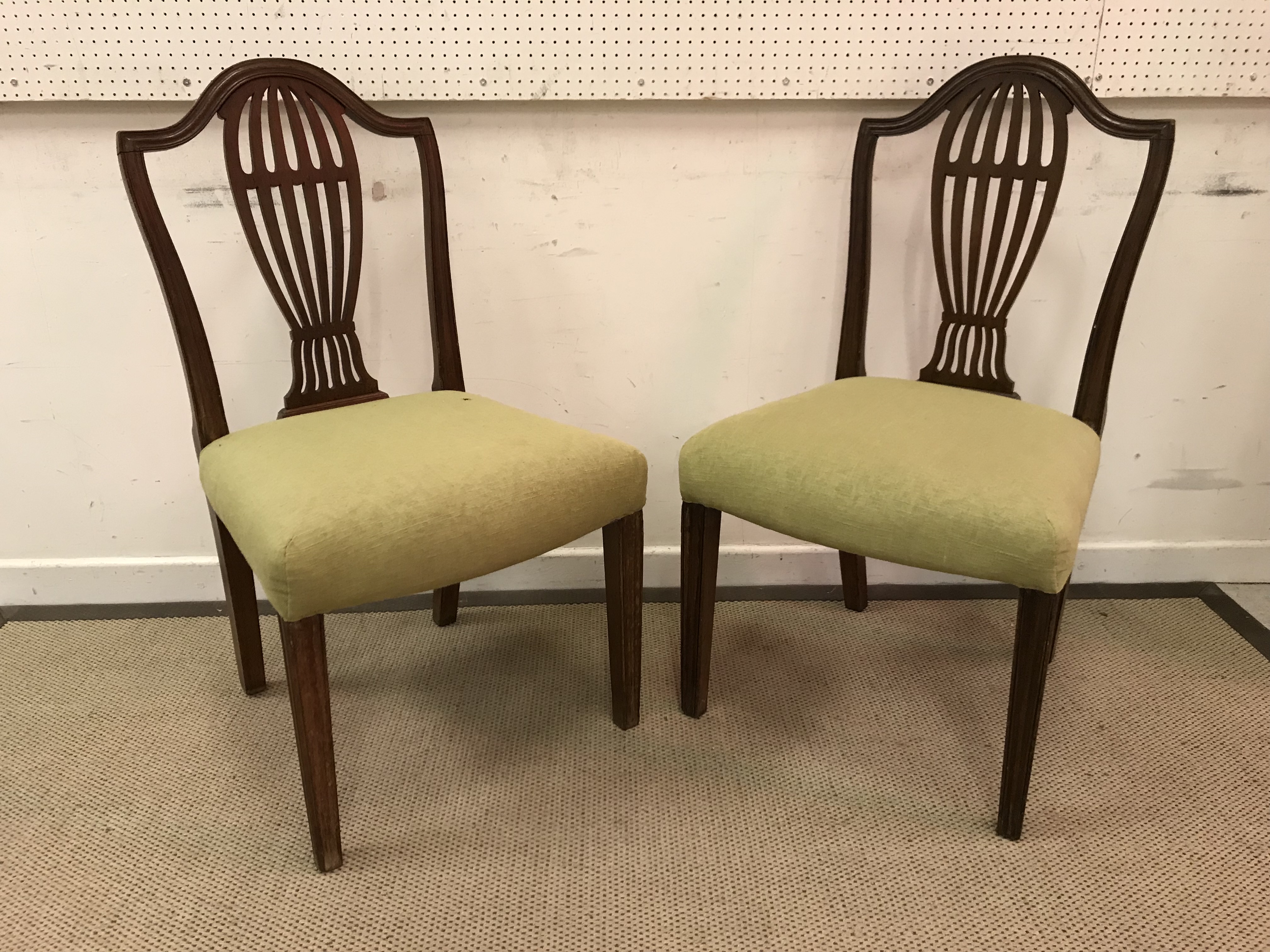 A pair of 19th Century mahogany framed dining chairs with serpentine top rails over a pierced back
