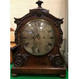 A 19th Century mahogany cased mantel clock with applied moulded scrolling foliate decoration,