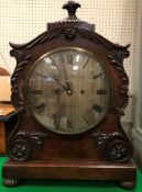 A 19th Century mahogany cased mantel clock with applied moulded scrolling foliate decoration,