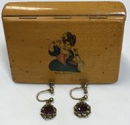 A pair of yellow metal mounted garnet set earrings together with a mauchline ware type box,