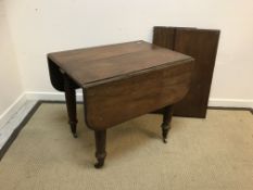 A Victorian mahogany drop-leaf Pembroke style extending dining table with two centre leaves,