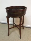 A brass bound mahogany oval jardiniere on stand attributed to Lister of Dursley 53 cm x 42 cm x 87.