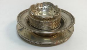 A collection of white metal dishes,