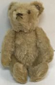 A 1950's Steiff miniature pale plush bear with jointed arms and button in ear,