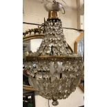 A 20th Century brass six light electrolier in the 19th Century style with cut glass drops,