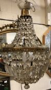 A 20th Century brass six light electrolier in the 19th Century style with cut glass drops,