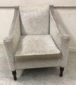 A set of four modern beige and cream upholstered scroll arm chairs on turned front legs,