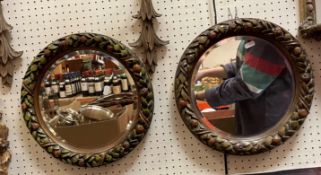 A pair of circular bevel edge wall mirrors with painted fruit and foliate frames, 36.