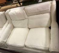 A Wesley Barrell cream ground two seat scroll arm sofa,