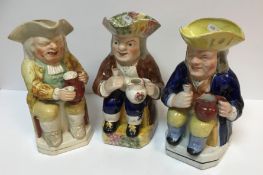 A collection of three 19th Century Toby jugs as "Toby Philpott seated with jug of ale upon his left