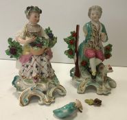 A pair of Chelsea figures of "Man seated with gun and bird in his hand",