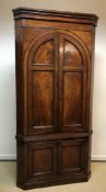 A George III mahogany freestanding corner cupboard,