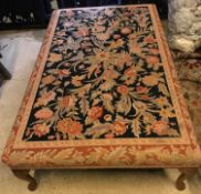 A modern floral tapestry upholstered rectangular drawing room stool on beech cabriole legs to pad