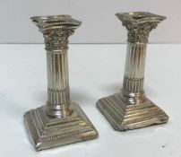 A pair of Corinthian column style candlesticks of small proportion (by Alexander Clark & Co.