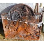 A cast iron fire back depicting St.