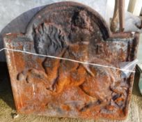 A cast iron fire back depicting St.