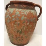A terracotta and foliate hand painted two handled urn in the Cypriot manner 38 cm high x 34 cm wide