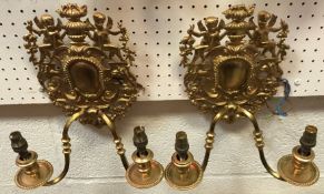 A pair of 20th Century gilt brass twin light wall sconces in the Rococo taste,