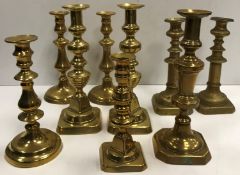 Two pairs and five various brass candlesticks