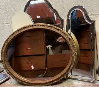 A gilt framed oval wall mirror in the Rococo style with foliate and ribbon decoration,