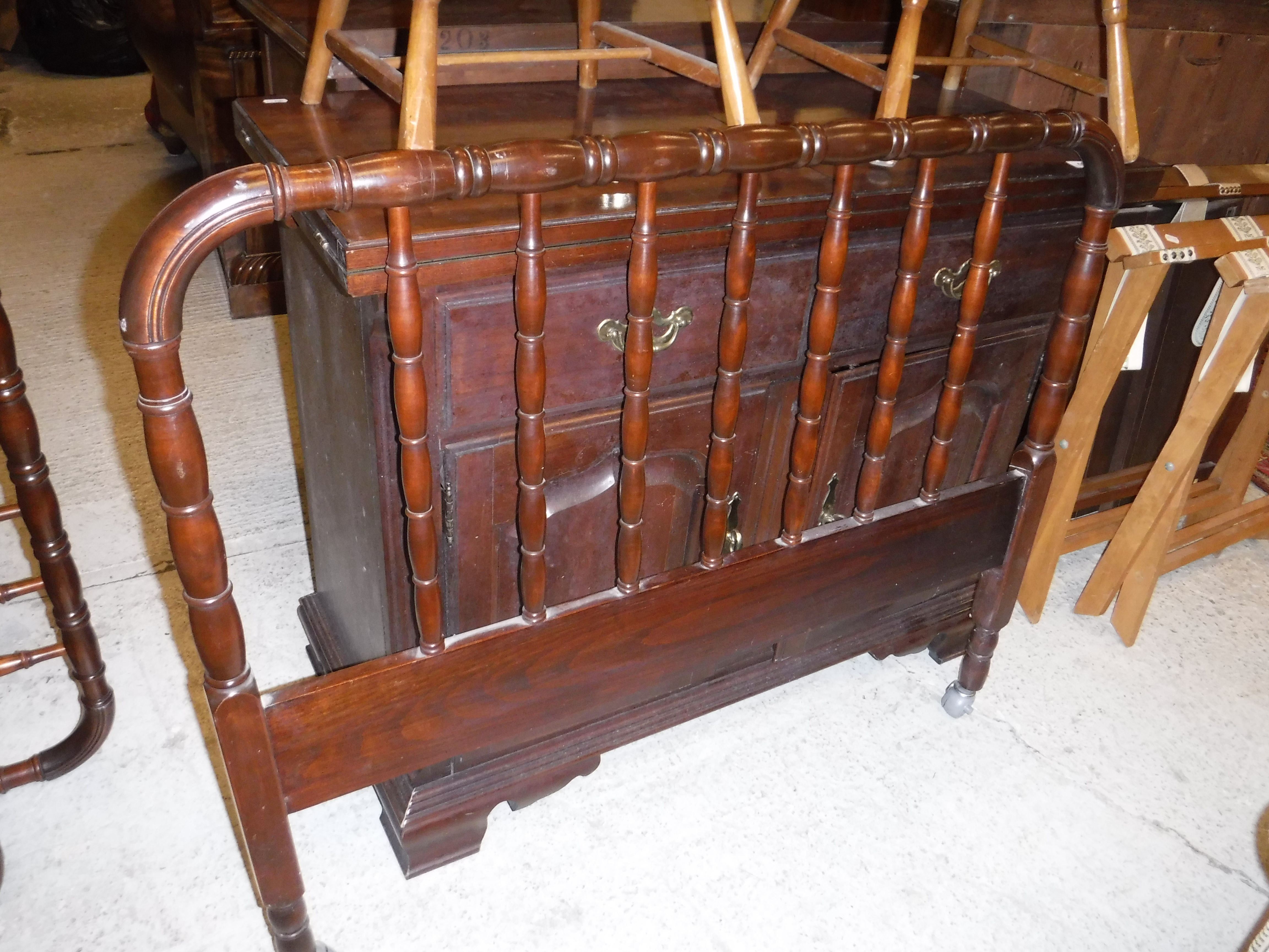 A pair of modern mahogany single bedsteads with turned and ringed railed ends,