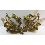 A pair of early 20th Century gilt brass wall lights as five branch candle holders with grape and