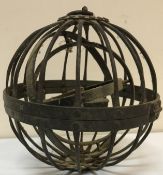 A wrought iron spherical gimbal whaling oil lamp together with a Middle Eastern brass embellished