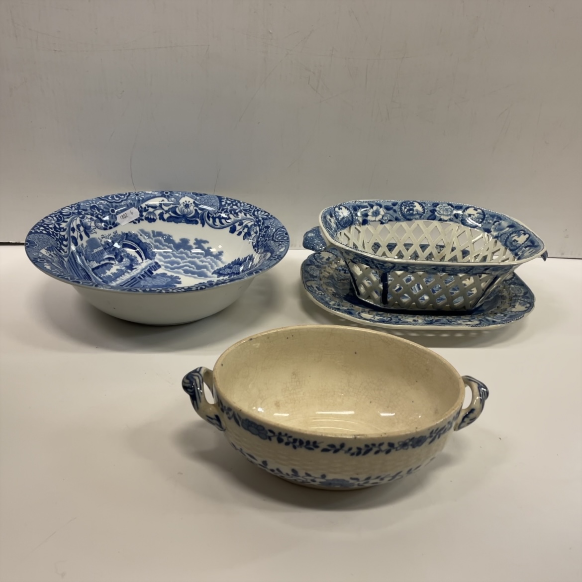 An early 19th Century blue and white transfer decorated pottery chestnut basket and stand,