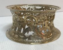 An Edwardian silver Irish dish ring with scrolling and figural decoration with buildings (by James