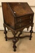 An early 20th Century walnut and feather-banded bureau in the early 18th Century manner,
