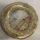 A pair of early 20th Century porcelain cabinet plates with hand-painted decoration of Highland