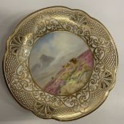 A pair of early 20th Century porcelain cabinet plates with hand-painted decoration of Highland