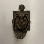 A 19th Century cast copper door knocker as a twin-tailed mermaid holding a shell, 12.5 cm long x 6.