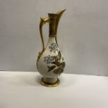 A Royal Worcester blushware pear shaped ewer with floral spray decoration raised on a circular foot