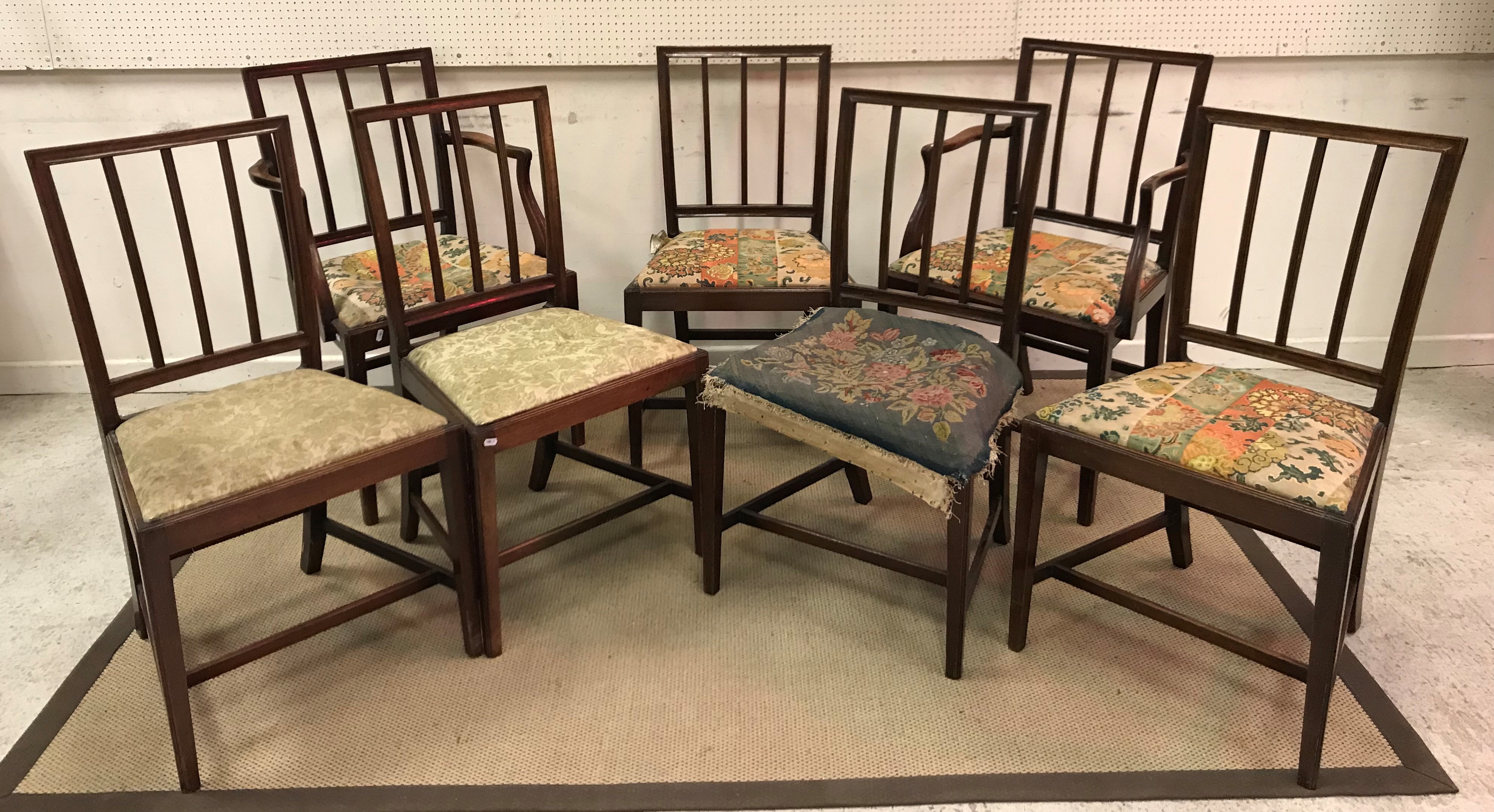 A set of eight 19th Century mahogany dining chairs with reeded back splats over drop-in seats on