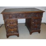 A Victorian carved oak Gothic Revival double pedestal desk,