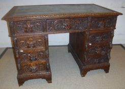 A Victorian carved oak Gothic Revival double pedestal desk,