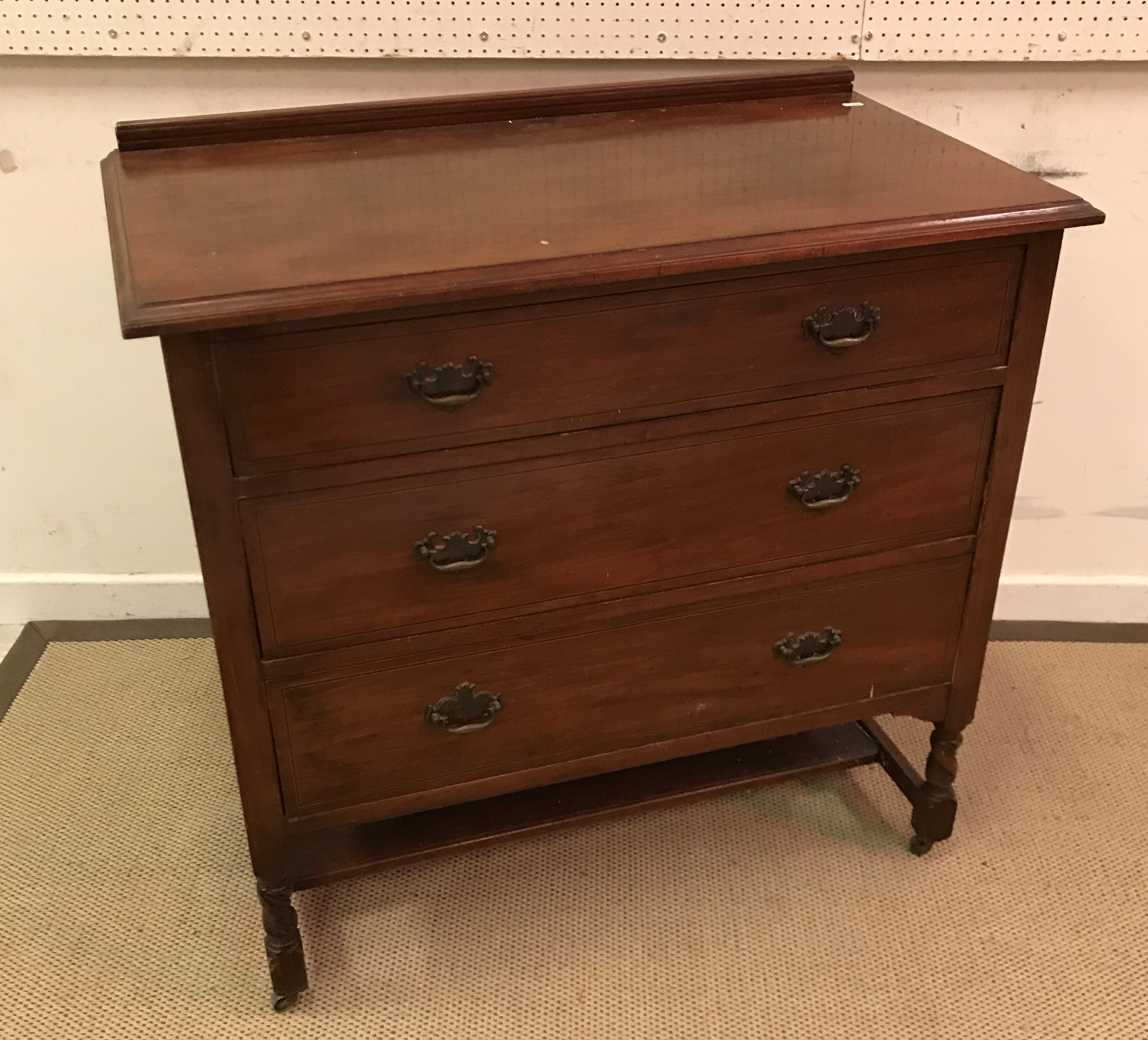 An early 20th Century mahogany bow fronted chest of two short over two long graduated drawers on