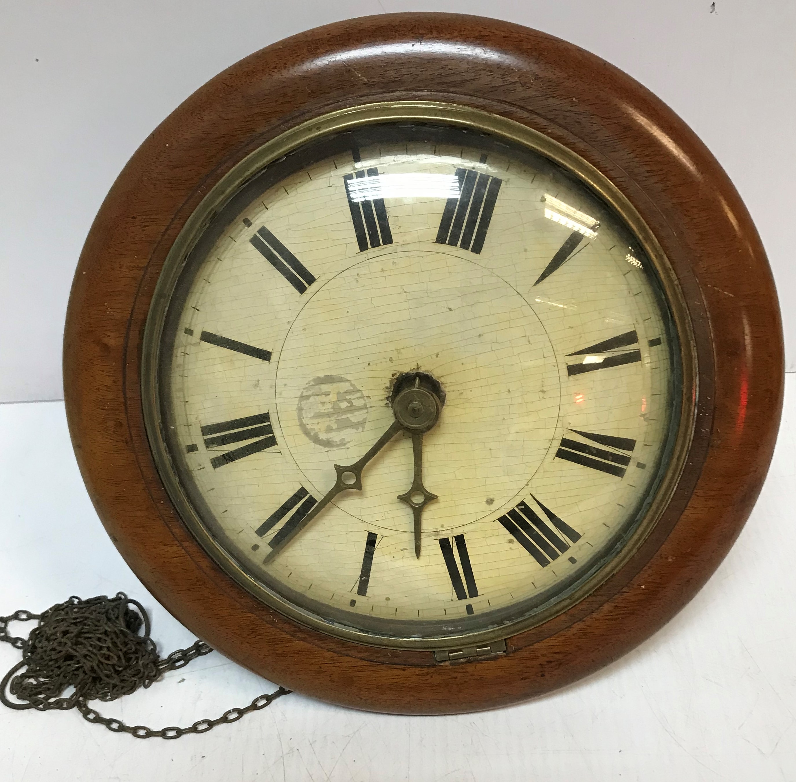 A Victorian postman's alarm clock with mahogany surround and painted dial with Roman numerals,