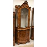 A modern Italian walnut and marquetry inlaid serpentine fronted display cabinet, the upper section