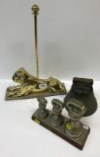 A graduated set of three plated brass bell weights (4 lb, 2 lb and 1 lb) on stand, a brass "lion"