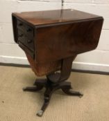 A 19th Century mahogany drop-leaf work table, with two drawers above a work basket on U shaped