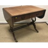 A reproduction mahogany drop-leaf sofa table in the Regency style, the cross-banded top with