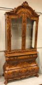 A modern Italian walnut and marquetry inlaid display cabinet in the Dutch taste with two glazed