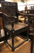 A 17th Century oak Wainscott type chair, the lunette carved top rail over a foliate medallion