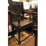 A 17th Century oak Wainscott type chair, the lunette carved top rail over a foliate medallion