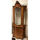 A modern Italian walnut and marquetry inlaid serpentine fronted display cabinet, the upper section