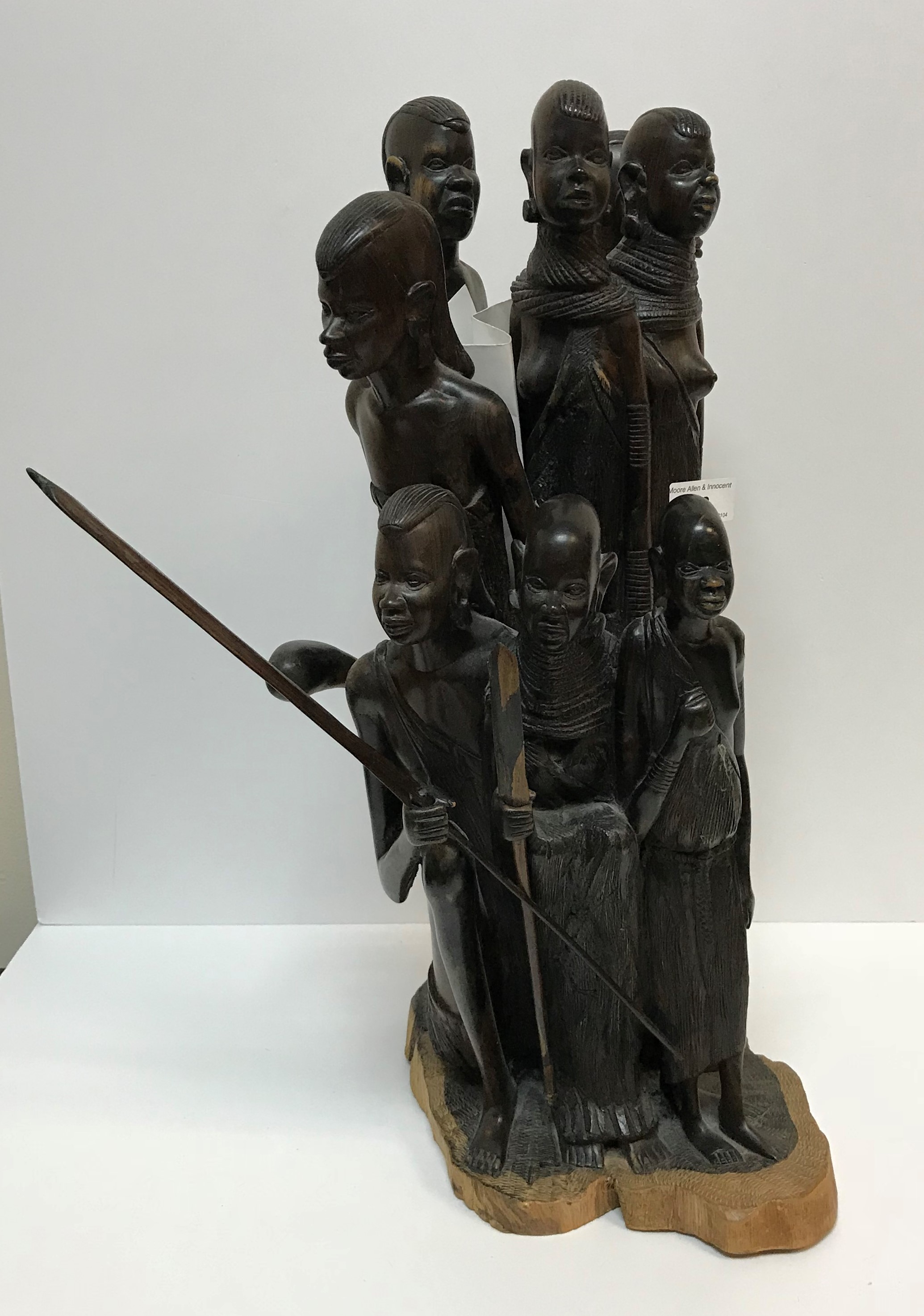 A 20th Century carved coromandel or king ebony Masai figure group depicting eight figures, some