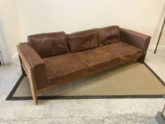 A mid 20th Century oak framed brown leather upholstered three seat sofa in the Scandinavian taste,