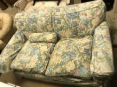 A circa 1900 upholstered two seat sofa with pale floral loose covers, approx 158 cm wide x 90 cm